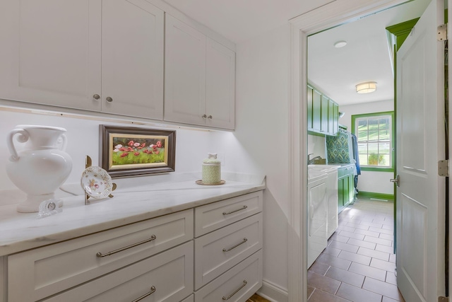 210 Green Rd, Franklin, TN 37069 - kitchen featuring separate washer and dryer, white cabinets, tile patterned floors, and light stone countertops