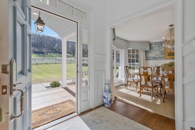 210 Green Rd, Franklin, TN 37069 - foyer entrance featuring plenty of natural light, wood finished floors, a decorative wall, a chandelier, and ornamental molding