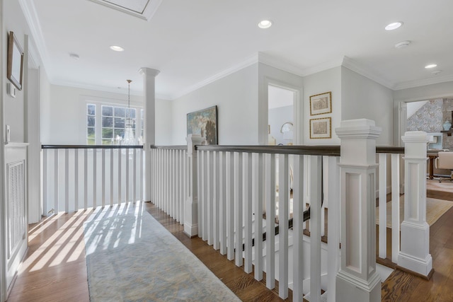 corridor with wood-type flooring and crown molding