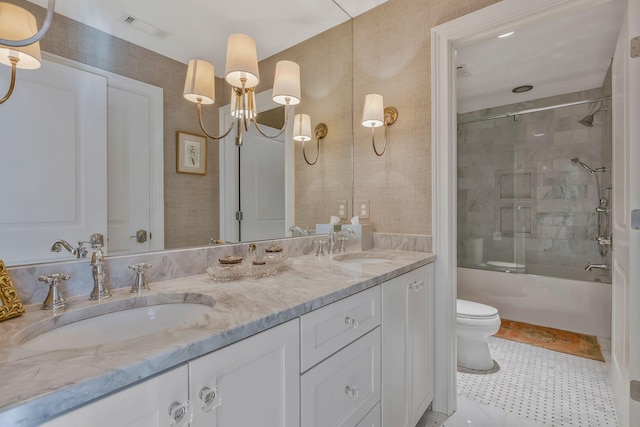 full bathroom featuring tile patterned floors, vanity, bath / shower combo with glass door, and toilet