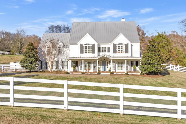 210 Green Rd, Franklin, TN 37069 - view of front of property with a porch, a chimney, a fenced front yard, and a metal roof