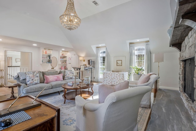 living room with high vaulted ceiling, a stone fireplace, and a notable chandelier