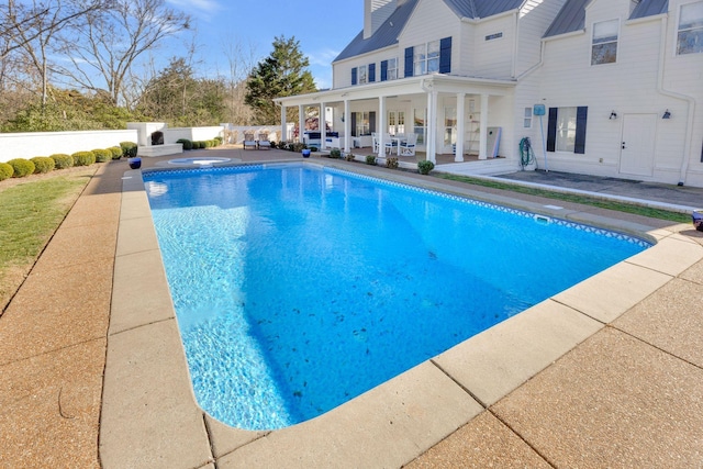 view of swimming pool with a patio area and an in ground hot tub