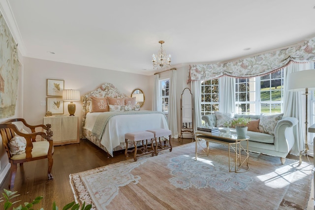 bedroom with a notable chandelier, dark hardwood / wood-style flooring, and ornamental molding