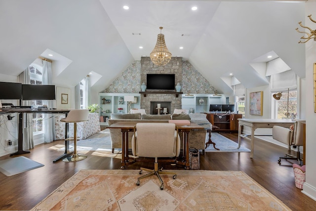 living room with dark hardwood / wood-style flooring, a fireplace, high vaulted ceiling, and a chandelier