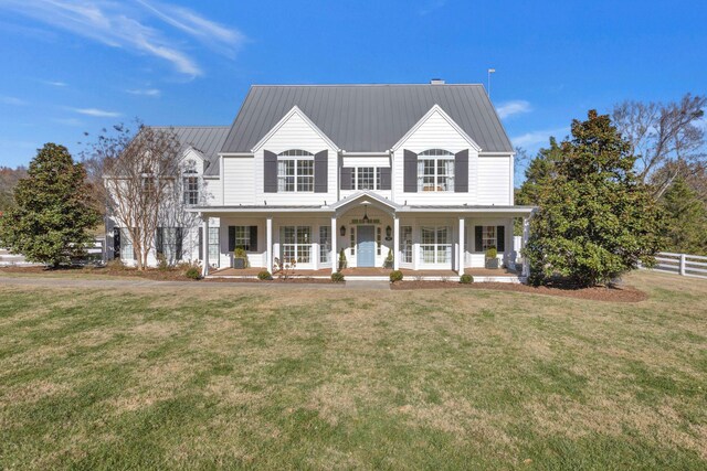 view of front facade with covered porch and a front yard