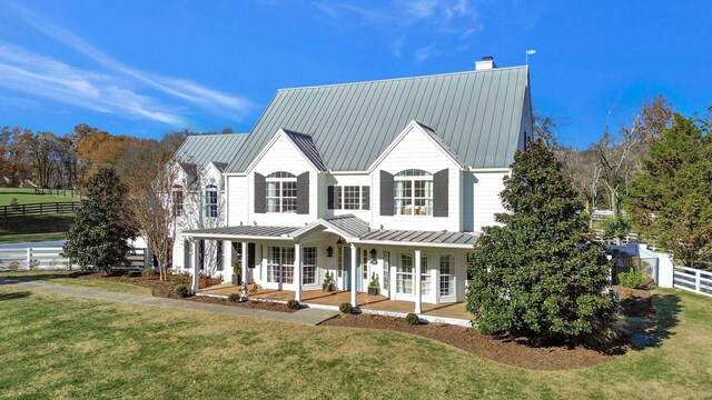 view of front of house with a porch and a front lawn