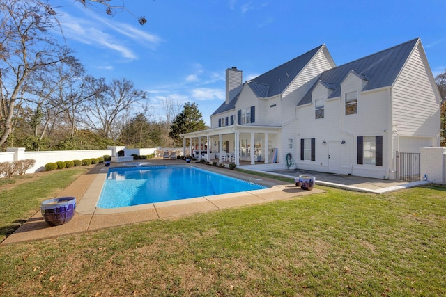 view of swimming pool with a patio and a lawn