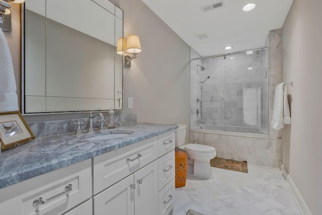 full bathroom featuring vanity, toilet, and bath / shower combo with glass door