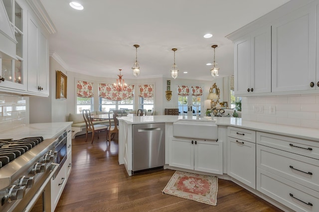 kitchen featuring decorative backsplash, stainless steel appliances, white cabinets, and a wealth of natural light