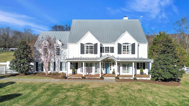 210 Green Rd, Franklin, TN 37069 - view of front of house featuring a standing seam roof, a porch, a front lawn, and a metal roof