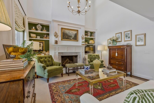 210 Green Rd, Franklin, TN 37069 - sitting room with a towering ceiling, a tiled fireplace, a chandelier, and built in features