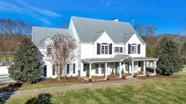 210 Green Rd, Franklin, TN 37069 - view of front of house with a porch, a front lawn, a standing seam roof, a chimney, and a metal roof