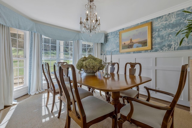 carpeted dining space with a notable chandelier and ornamental molding