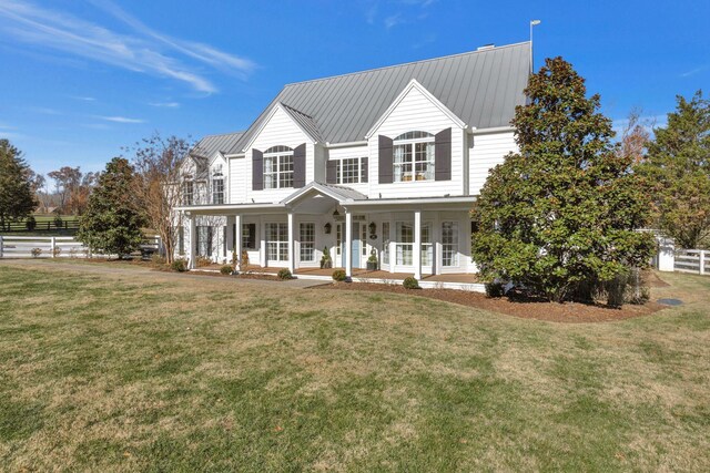 view of front of house with covered porch and a front yard