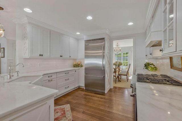 210 Green Rd, Franklin, TN 37069 - kitchen with appliances with stainless steel finishes, crown molding, white cabinets, a chandelier, and dark wood-type flooring