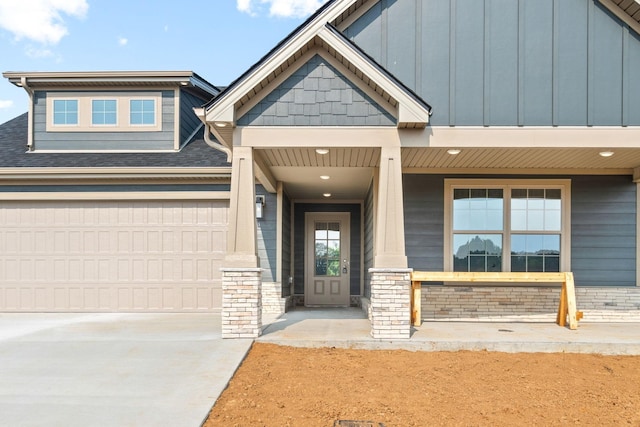 entrance to property featuring a porch and a garage