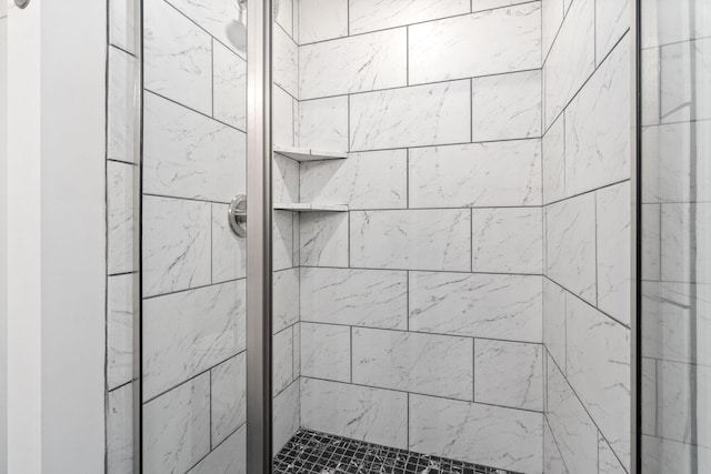 bathroom with tiled shower