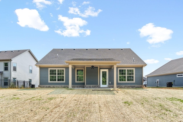 rear view of house with a yard and cooling unit