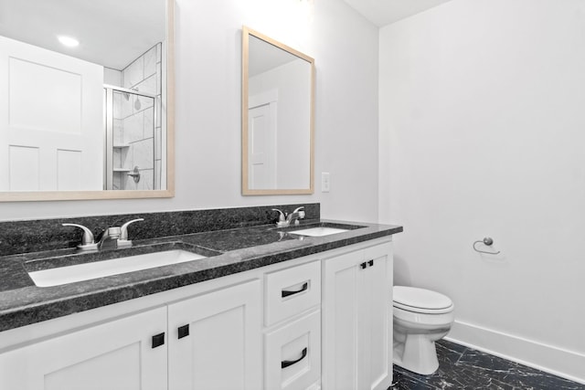 bathroom featuring a shower, vanity, and toilet