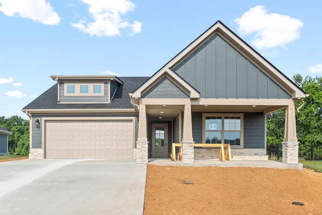 craftsman inspired home with covered porch and a garage