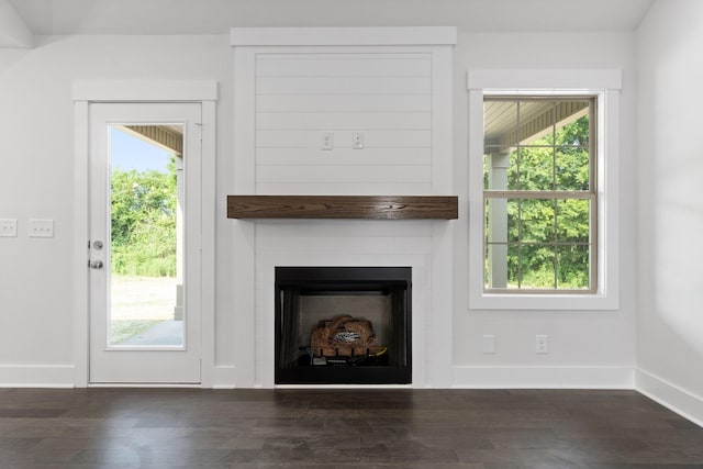 unfurnished living room featuring dark hardwood / wood-style flooring