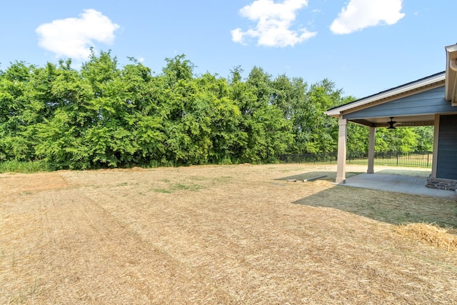 view of yard with ceiling fan and a patio area