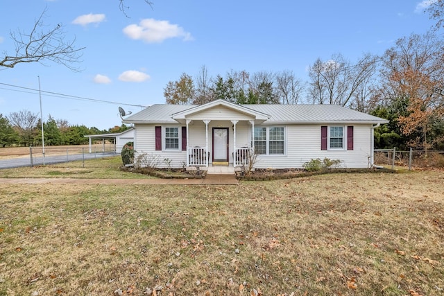 ranch-style home with covered porch, a carport, and a front lawn