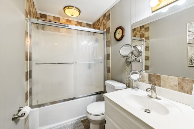 full bathroom with vanity, toilet, shower / bath combination with glass door, and crown molding