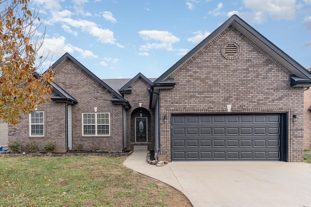 front of property featuring a front yard and a garage