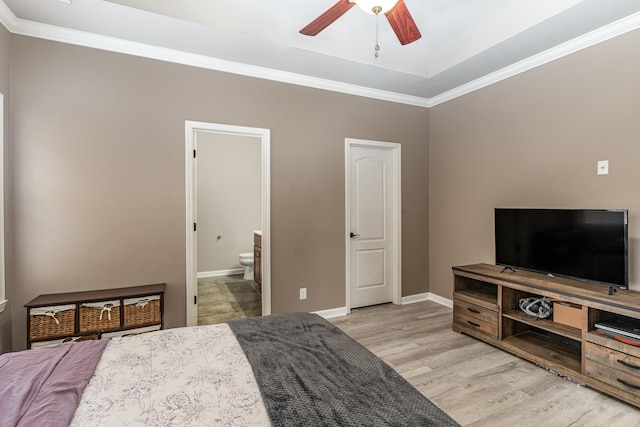 bedroom featuring ensuite bathroom, light hardwood / wood-style flooring, ceiling fan, and ornamental molding