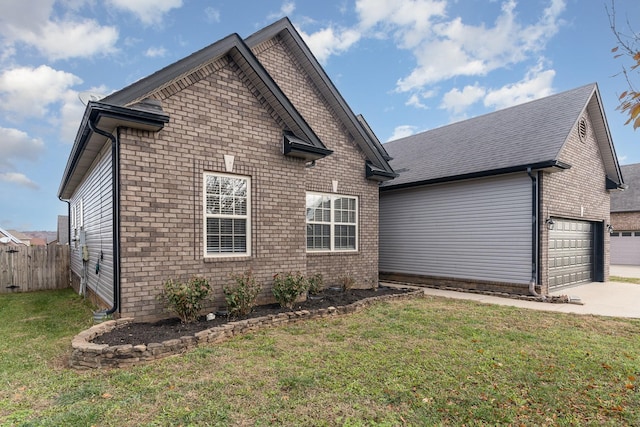 view of home's exterior with a garage and a yard