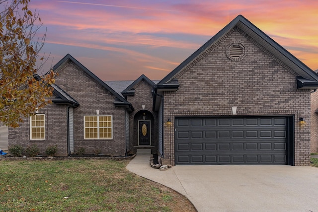 view of property with a garage and a yard