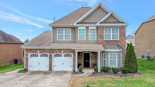 view of front facade featuring central AC, a garage, and a front lawn