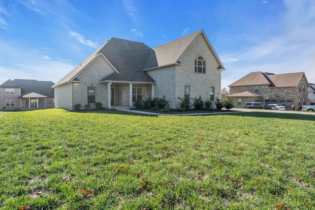 view of front of property featuring brick siding and a front lawn