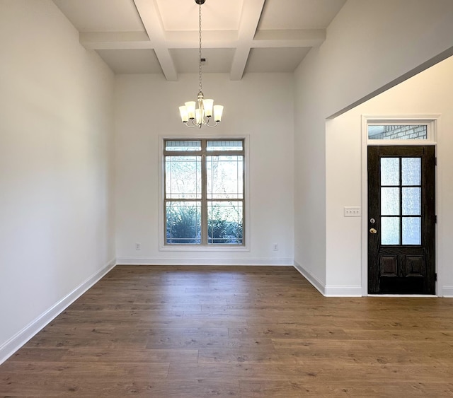 foyer entrance featuring dark wood-style floors, baseboards, a chandelier, and a wealth of natural light