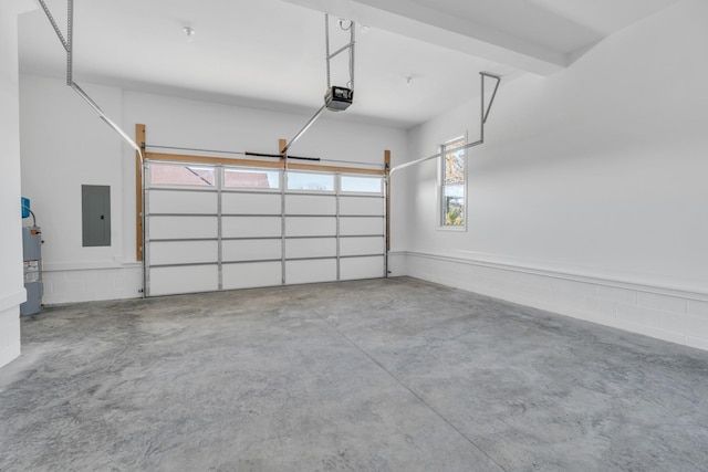 garage featuring a garage door opener, concrete block wall, electric panel, and electric water heater