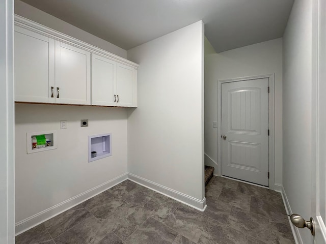 clothes washing area with hookup for a washing machine, cabinet space, electric dryer hookup, and baseboards