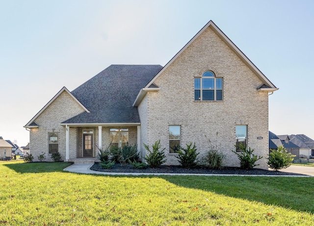 traditional-style house with a front lawn and brick siding