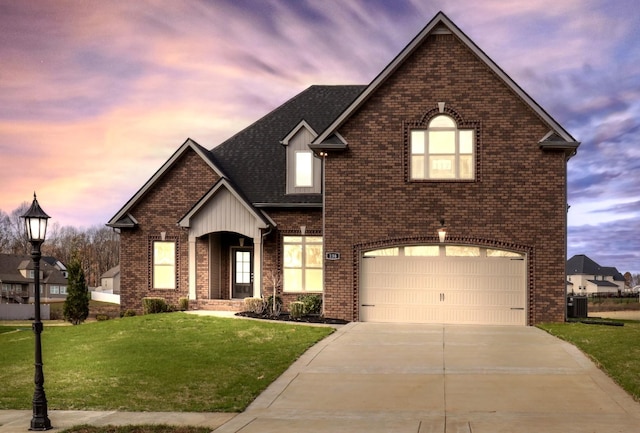 view of front property featuring cooling unit, a yard, and a garage