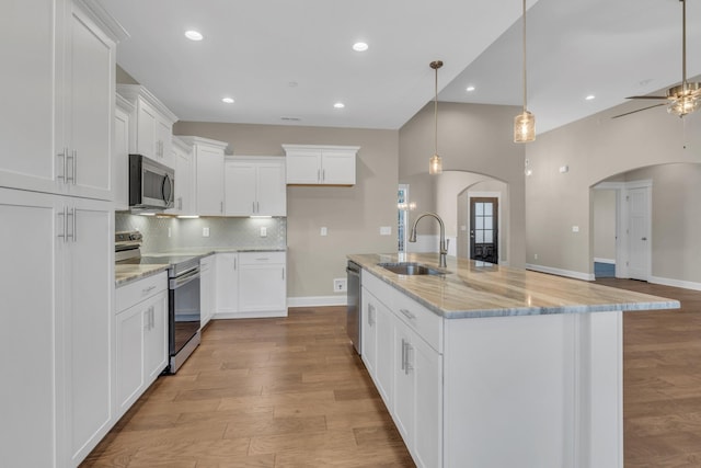 kitchen featuring sink, white cabinetry, a kitchen island with sink, and appliances with stainless steel finishes