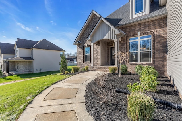 entrance to property featuring a lawn