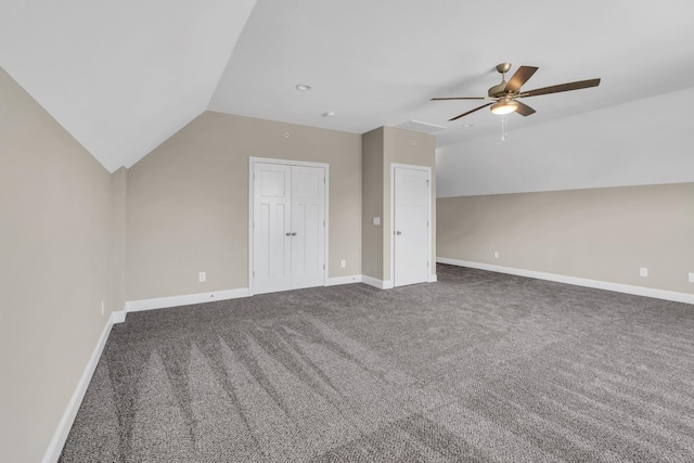 additional living space with vaulted ceiling, ceiling fan, and dark colored carpet