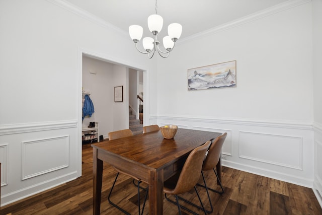 dining room featuring crown molding, dark hardwood / wood-style flooring, and a chandelier