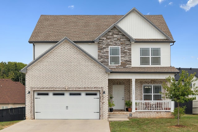 view of front of property with a front yard, a porch, and a garage