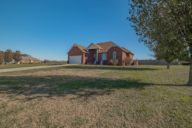 view of front facade with a front yard, fence, and a garage