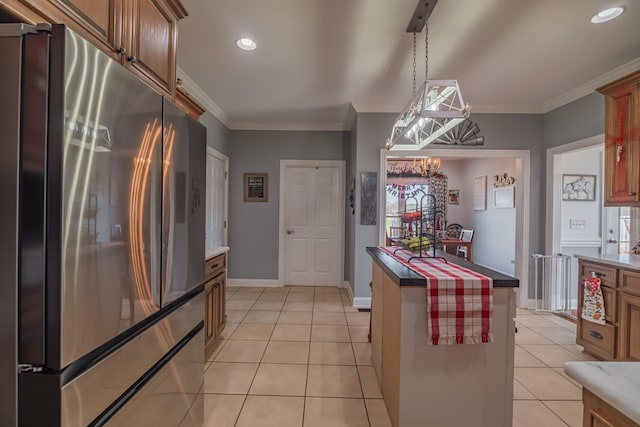 kitchen with pendant lighting, light tile patterned flooring, stainless steel refrigerator, and an inviting chandelier