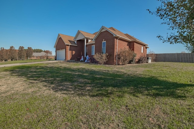 view of front of house featuring a garage and a front lawn