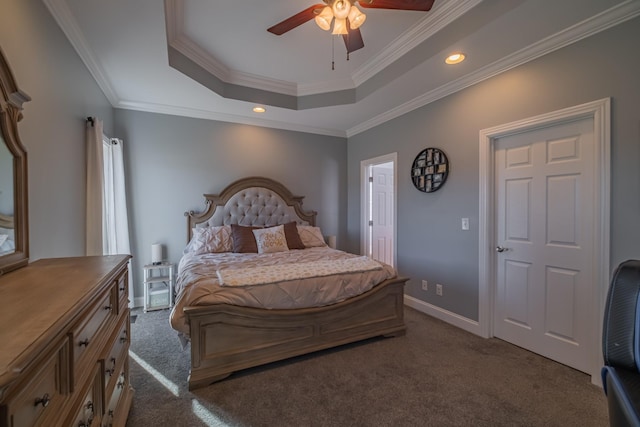 carpeted bedroom featuring a tray ceiling, ceiling fan, and crown molding