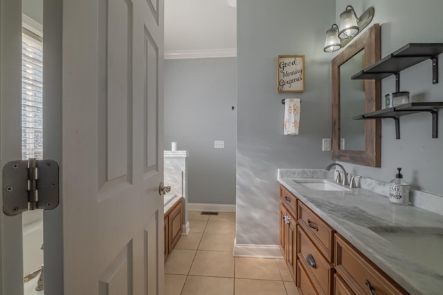 full bath featuring tile patterned flooring, crown molding, baseboards, a bathing tub, and vanity